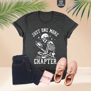 a t - shirt that says just one more charter next to a pair of jeans