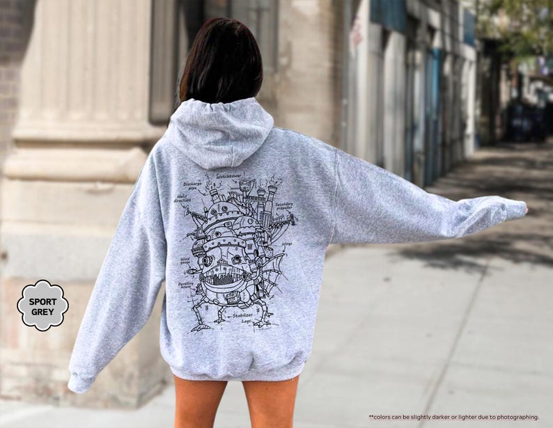 May include: A gray hooded sweatshirt with a black and white illustration of a flying machine on the back. The illustration is labeled with the different parts of the machine.