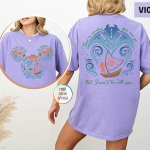 May include: A purple t-shirt with a graphic of a boat and waves on the back. The text "There is nowhere you can go that I won't be with you..." is printed on the back of the shirt.
