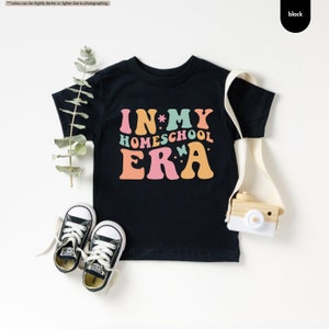 a t - shirt that says in my homeschool era next to a pair