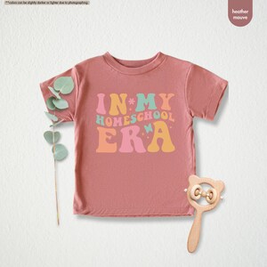 a pink t - shirt with the words in my home school era on it