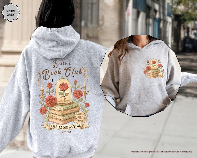 Puede incluir: Sudadera con capucha gris deportivo con un dise&ntilde;o que presenta una rosa en una c&uacute;pula de cristal, libros y el texto "Belle's Book Club". El dise&ntilde;o trasero incluye la frase "Tale as Old as Time" y el a&ntilde;o "EST. 1991".