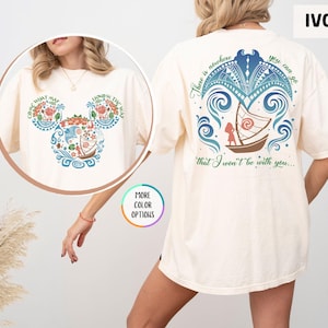 May include: Ivory t-shirt with a blue and green design of a boat and waves. The design includes the text "There is nowhere you can go that I won't be with you..." and a Mickey Mouse head silhouette with the text "Come what may, know the way".