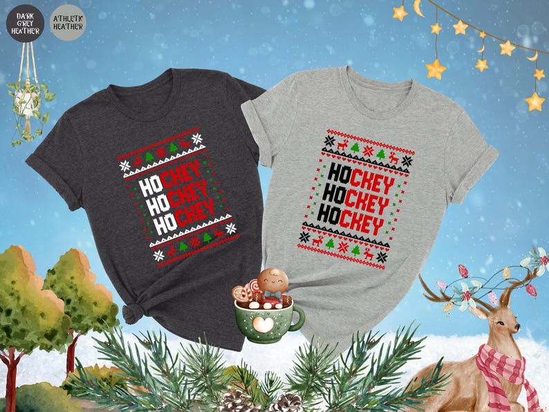 May include: Two Christmas themed t-shirts with the words "Hockey" repeated three times on each shirt. One shirt is dark heather grey and the other is light grey.