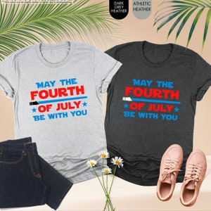 a couple of t - shirts sitting next to each other
