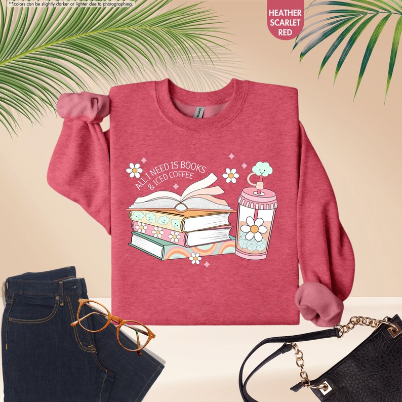 a sweater with a book and a drink on it