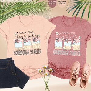 a couple of shirts that are next to a plant