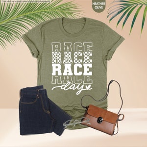 a t - shirt with the words race race and a purse next to it