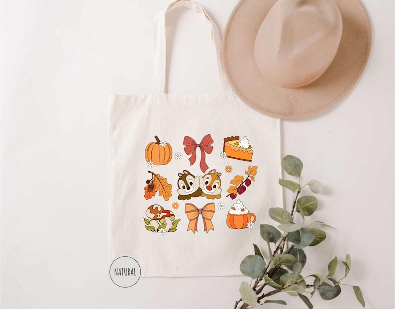 a white tote bag with a bunch of fall items on it