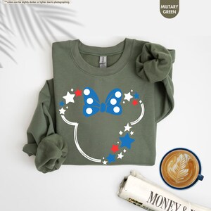 a mickey mouse shirt next to a cup of coffee