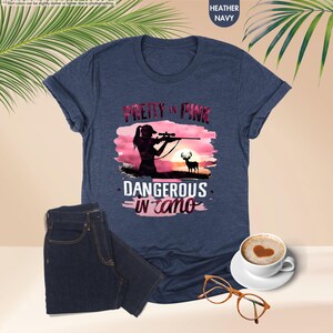 a women's t - shirt with a picture of a man holding a gun