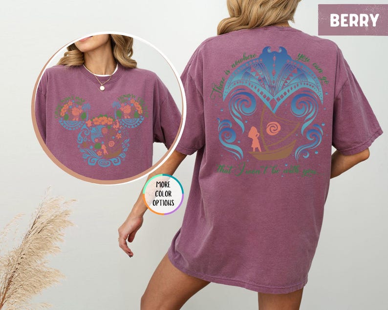May include: A berry colored t-shirt with a blue and pink graphic design on the back. The graphic features a stylized image of a boat with a person in it. The text "There is nowhere you can go that I won't be with you" is printed on the shirt.