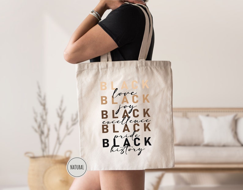 a woman carrying a black tote bag