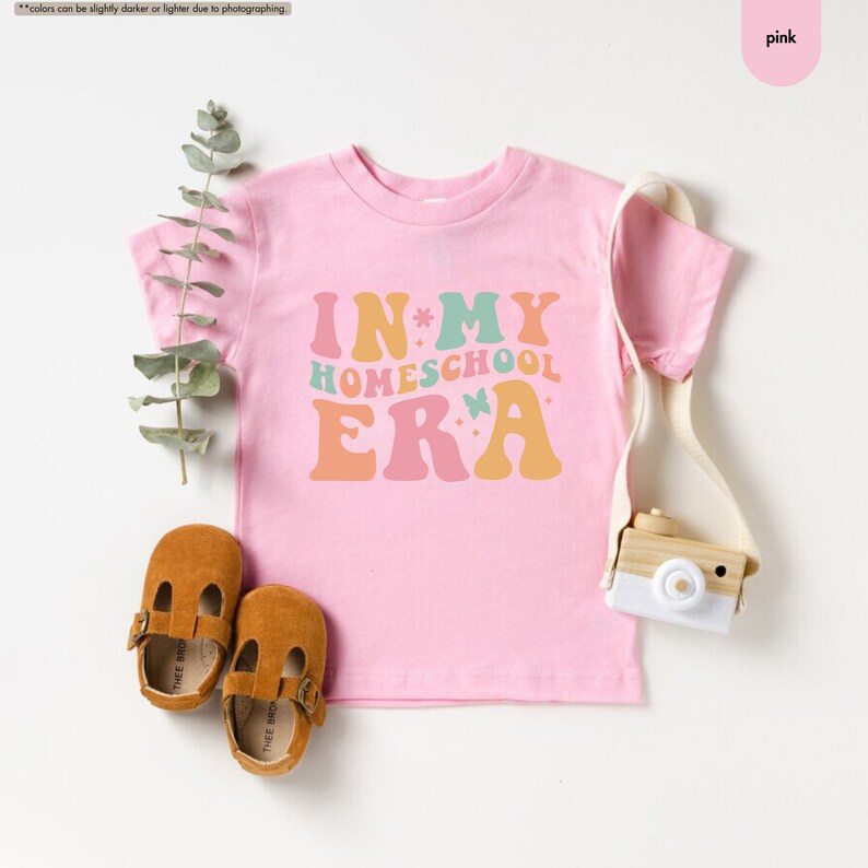 a pink shirt with the words in my homeschool era next to a pair