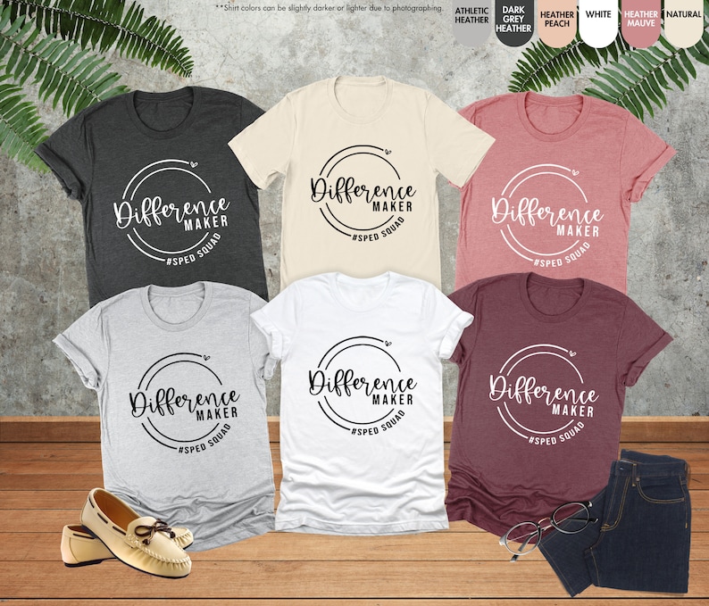 a group of women's t - shirts sitting on top of a wooden floor
