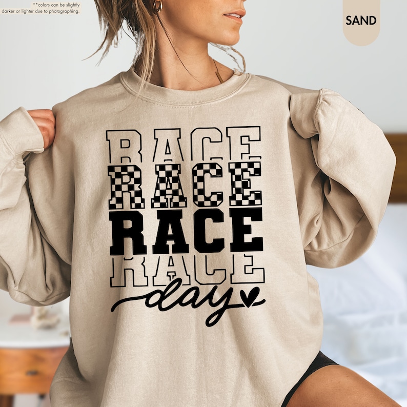 a woman wearing a sweatshirt that says race race race race day