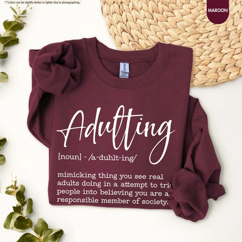 a t - shirt with the words adulting printed on it
