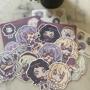 May include: A collection of colourful anime character stickers featuring various characters with different hairstyles and expressions. The stickers are printed on white paper and have a glossy finish.