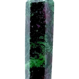 May include: A faceted, elongated crystal with a pointed top. The stone features a mix of colours, including deep green, dark red, and black. The crystal is set against a white background.