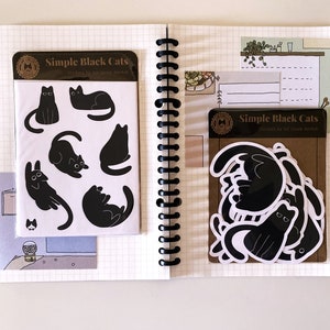 May include: Two sheets of stickers featuring black cats in various poses. The stickers are labeled "Simple Black Cats" and are packaged in a clear plastic sleeve.