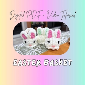 May include: Three white crochet Easter baskets shaped like bunnies with pink and green accents. The image includes the text "Digital PDF + Video Tutorial" and "EASTER BASKET".
