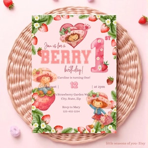May include: A pink birthday invitation with a strawberry theme. The text reads "Join us for a BERRY birthday!" with the number "1" and the name "Caroline". The invitation features illustrations of a girl in a strawberry hat and strawberries.