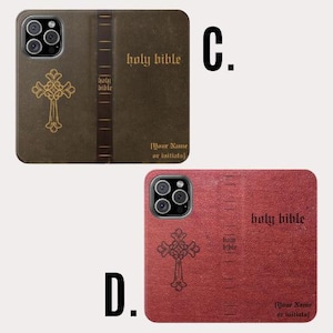 May include: Two phone cases with a book-like design. One is brown with a gold cross and the words "holy bible." The other is red with a similar cross and text. Both cases have space for personalization.