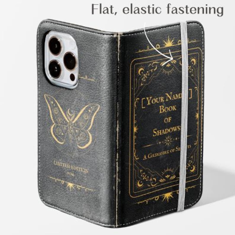 May include: Black leather phone case with a butterfly design and the text "LIMITED EDITION". The case is designed to look like a book, with the title "Book of Shadows" and a flat, elastic fastening.