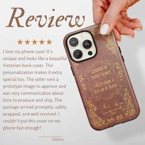 May include: A brown phone case with a vintage book cover design, featuring the text "LEGENDS OF [YOUR NAME] TALES FROM A REALM OF MAGIC" and "LIMITED EDITION 2023". The case is held by a hand.
