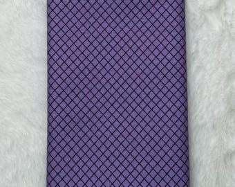 May include: A purple fabric with a black diamond pattern.