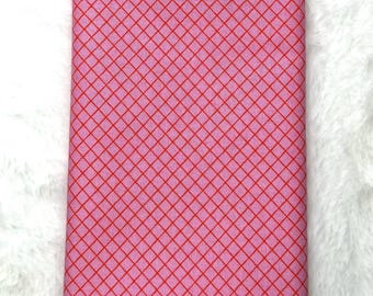 May include: Pink fabric with a red diamond pattern.