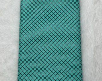 May include: A piece of turquoise blue fabric with a black diamond pattern.