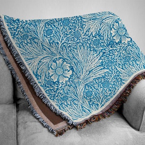 Blue William Morris Woven Blanket Draped over a Grey Couch