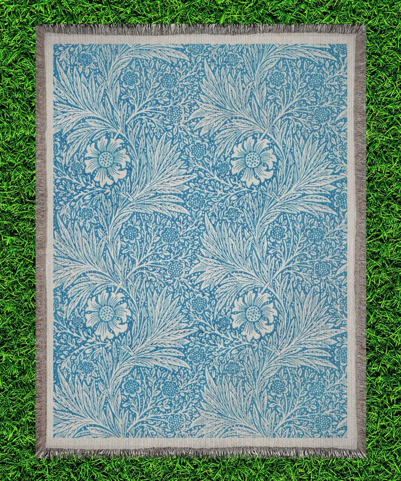 Blue William Morris Woven Blanket on top of  Bright Green Grass