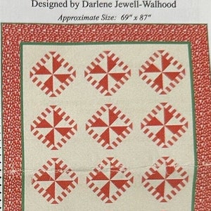 May include: A quilt pattern for a Peppermint Candies Quilt, designed by Darlene Jewell-Walhood. The quilt is made up of nine red and white squares with a peppermint candy design. The quilt is 69 inches by 87 inches.