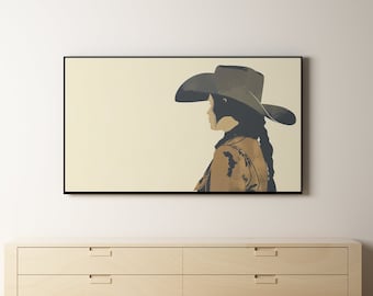 May include: A framed print of a woman wearing a cowboy hat, looking to the right. The background is a light beige color. The print is hanging on a white wall above a wooden dresser with three drawers.