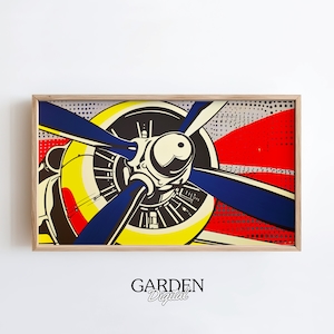 May include: A close-up of a vintage airplane propeller with a yellow, red, and blue color scheme. The propeller is set against a white background with a red, white, and blue polka dot pattern.