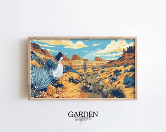 May include: A framed art print depicts a desert landscape with a woman in a white dress walking away from the viewer. The artwork features a color palette of tan, blue, and orange, with cacti and rock formations. The text "GARDEN Digital" is at the bottom.
