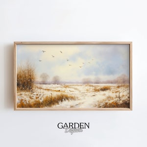 May include: A framed painting of a winter landscape with a snowy field, a dirt road, and a flock of birds flying overhead. The sky is a soft blue with hints of yellow and white clouds. The trees are bare and the ground is covered in snow.