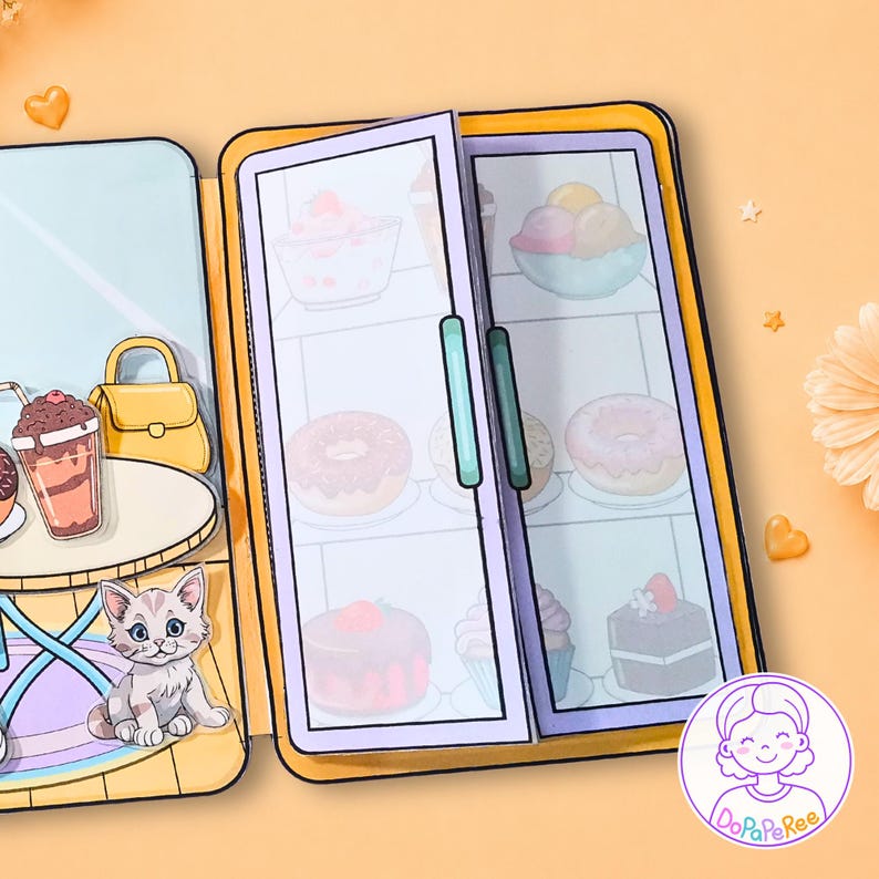 May include: A paper craft set featuring a double-door refrigerator filled with illustrations of ice cream, donuts, and cakes. To the left, a table holds a drink and a yellow handbag, accompanied by a small gray kitten illustration on a rug.