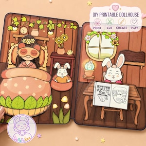 Op de afbeelding: Een DIY printbaar poppenhuisset met een geïllustreerde scène op twee pagina's. Links een personage in bed met een slaapmasker, rechts een konijn aan een bureau met een kleurboek. De tekst luidt DIY PRINTABLE DOLLHOUSE.