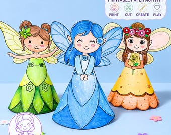 May include: Three paper fairy figures with cone-shaped dresses in green, blue, and yellow. The green fairy has brown hair and wings, the blue fairy has blue hair and wings, and the yellow fairy has brown hair with a flower crown and wings. Text reads: PRINTABLE PAPER ACTIVITY PRINT CUT CREATE PLAY.