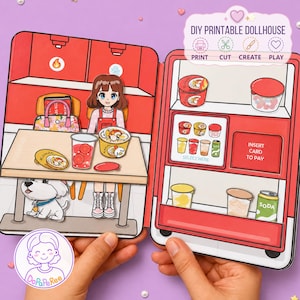 May include: A DIY printable dollhouse set featuring a cartoon character sitting at a table with a bowl of ramen, a drink, and a dog. The set includes a red vending machine with shelves of food and drink items, and text that reads DIY PRINTABLE DOLLHOUSE.