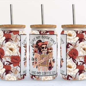 May include: Three stainless steel tumblers with a floral pattern and a skeleton holding a book and a cup. The text on the tumbler reads "I like my book spicy and my coffee icy".