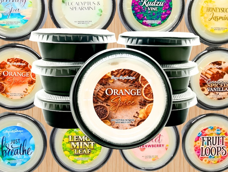 May include: A collection of round, black plastic cups filled with white soy wax melts. Each cup features a circular label with unique scent names and graphics, including Orange Spice, Serenity Spa, Eucalyptus & Spearmint, Kudzu Vine, Honeysuckle Jasmine, Cinnamon Spiced Vanilla, Just Breathe, Lemon Mint Leaf, Sweet Strawberry, and Fruit Loops.