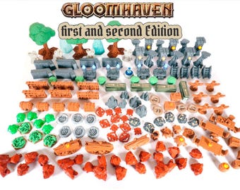 May include: A collection of miniature plastic game pieces for Gloomhaven first and second edition, including trees, stone pillars, treasure chests, rock formations, and various terrain obstacles in shades of green, gray, orange, and brown.