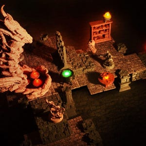 May include: A miniature dungeon diorama with stone brick flooring and walls. The scene includes a dragon head, a bookshelf, and several figurines. Lit with orange and green lights, creating a fantasy atmosphere.