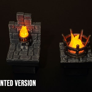 May include: Two miniature painted fire places with glowing orange flames. The fire places are made of stone and metal and are set on a black background.  The text "PAINTED VERSION" is at the bottom of the image.
