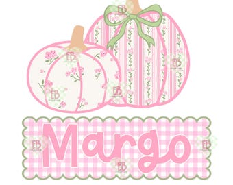 May include: Two decorative pumpkins with floral and striped patterns, and a green bow. The pumpkins are pink and white with a light brown stem. Below the pumpkins is the name "Margo" in pink letters on a pink and white checkered background.