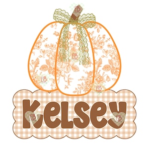 May include: A pumpkin illustration featuring an orange floral pattern and a decorative lace bow on top. Below the pumpkin is a scalloped rectangular sign with a light brown gingham background displaying the name Kelsey in brown letters.
